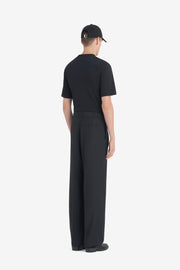 LOOSE SUIT PANT - Noir ÉTUDES STUDIO - détail du porte-clés gravé