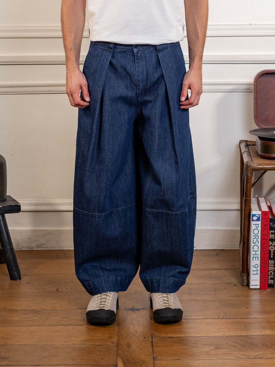 YMC Earth Deadbeat Trouser in indigo, worn, close front view of the pleats